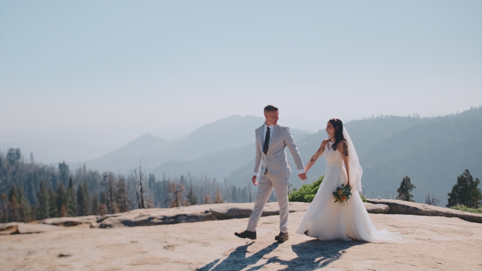 A newlywed couple walking on Beetlerock in Sequoia National Park in California.
