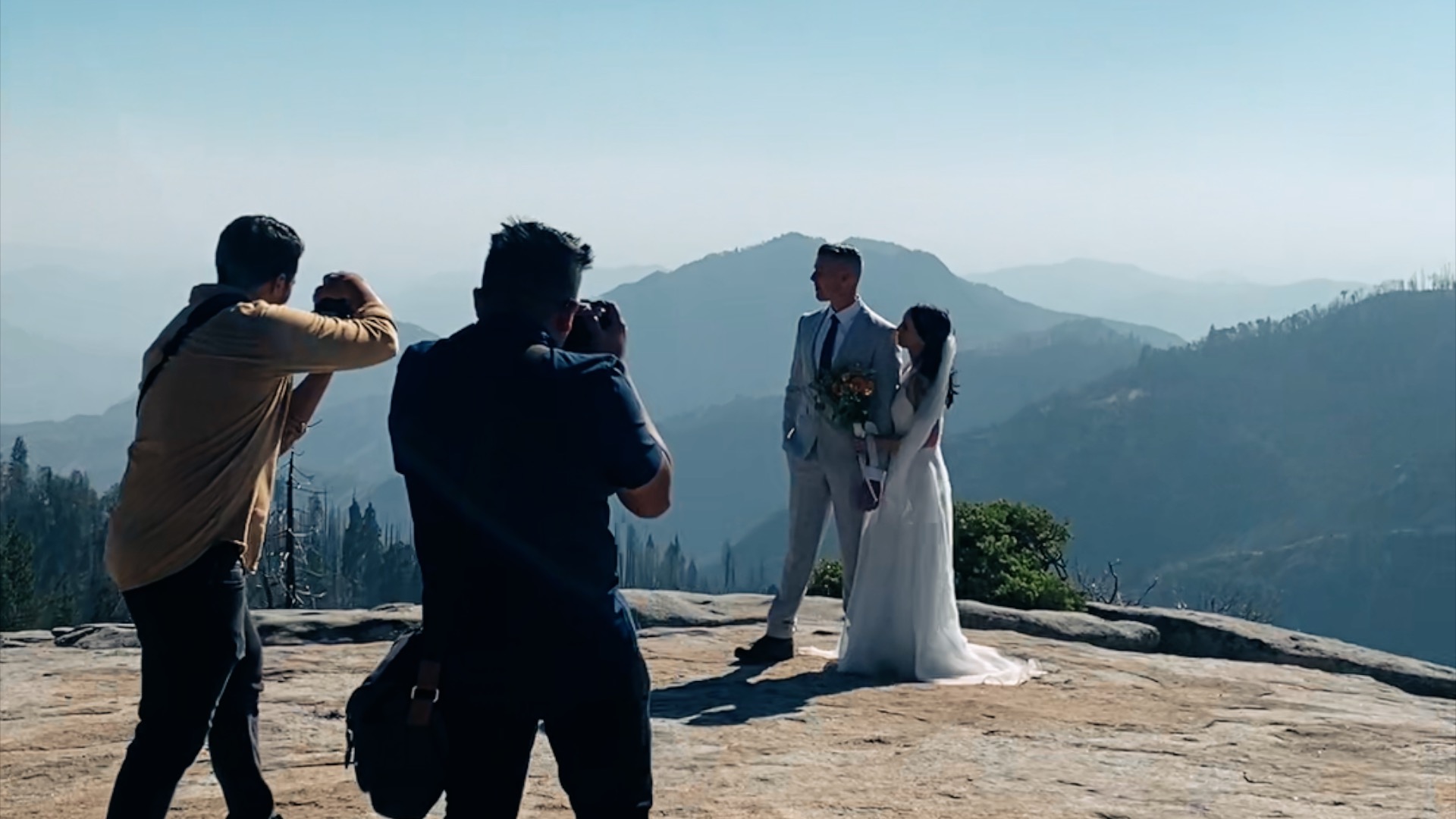 A wedding videographer and photographer capturing a newlywed couple in Sequoia National Park.